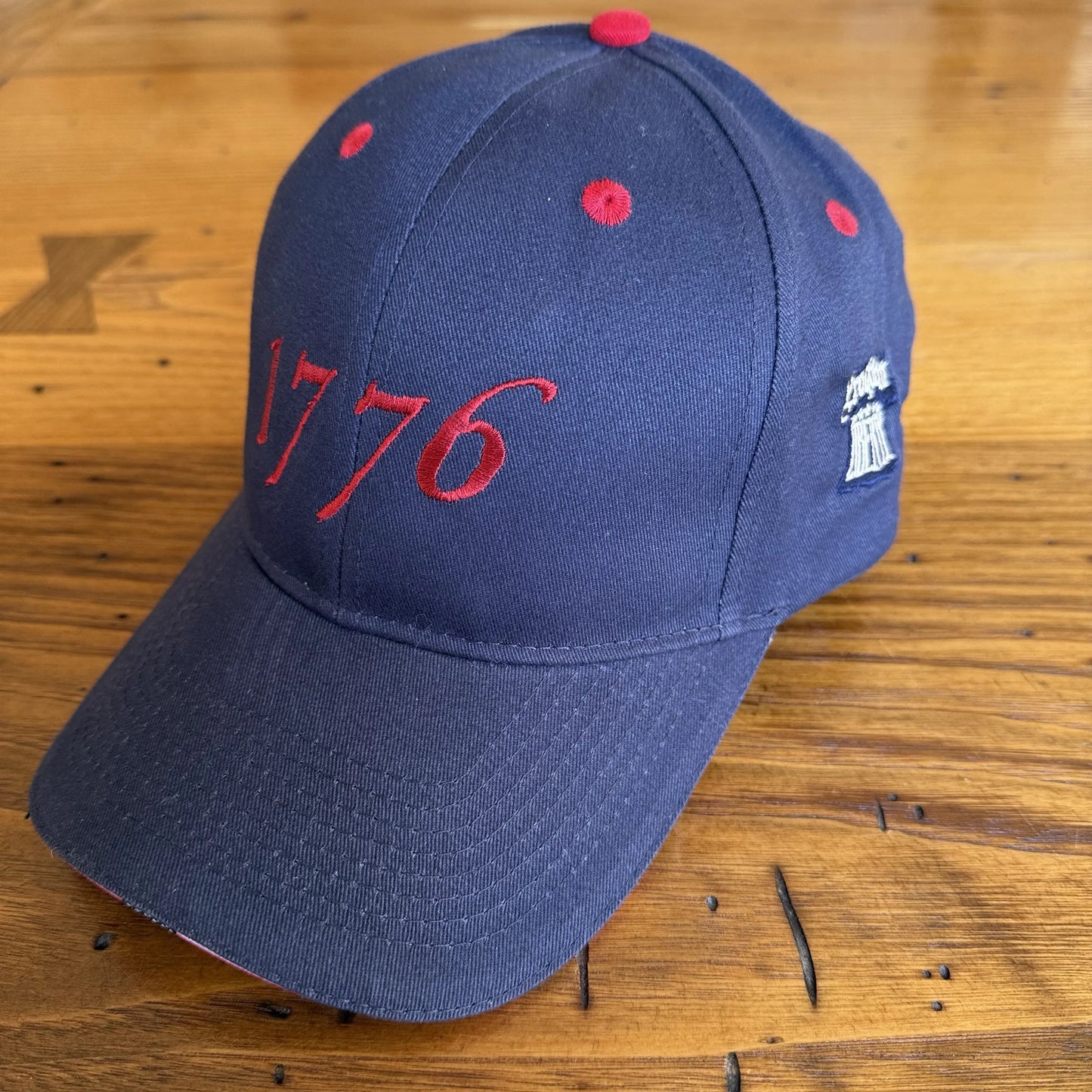 Side angle of Embroidered "1776" cap with Proclaim Liberty — Dark blue with flag brim from The History List store