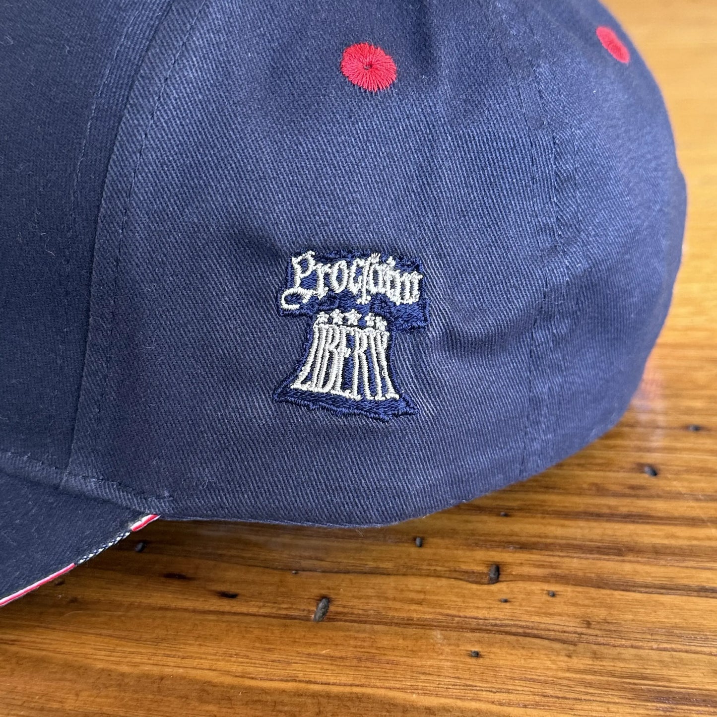 Side view of Embroidered "1776" cap with Proclaim Liberty — Dark blue with flag brim from The History List store