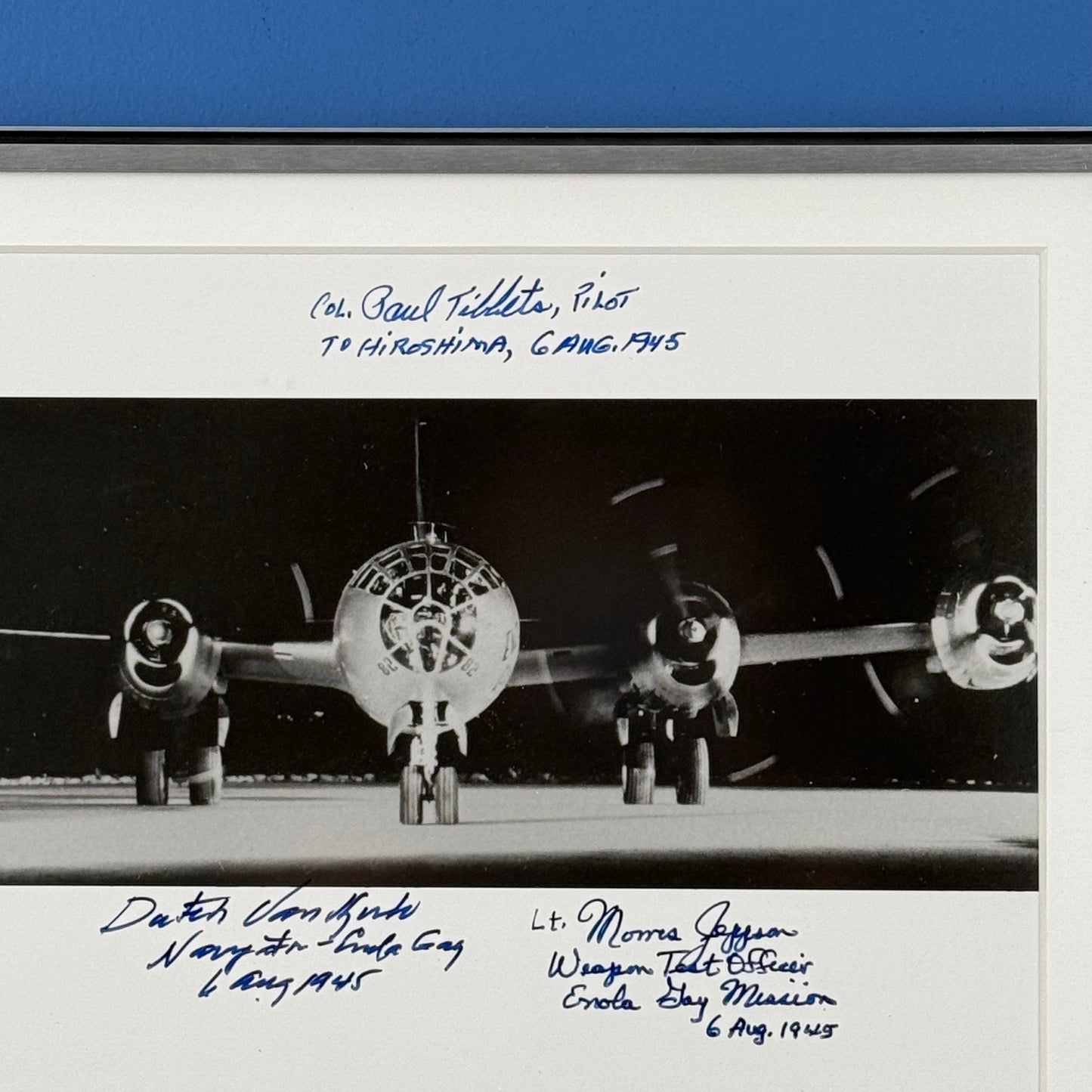 Photo of the Enola Gay signed by the pilot, navigator, and weapons officer — with COA