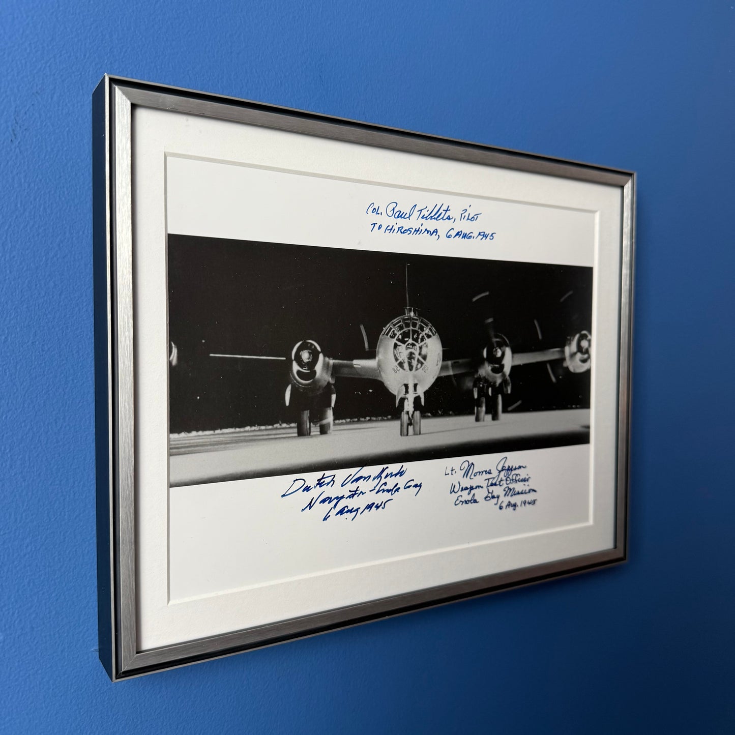 Photo of the Enola Gay signed by the pilot, navigator, and weapons officer — with COA