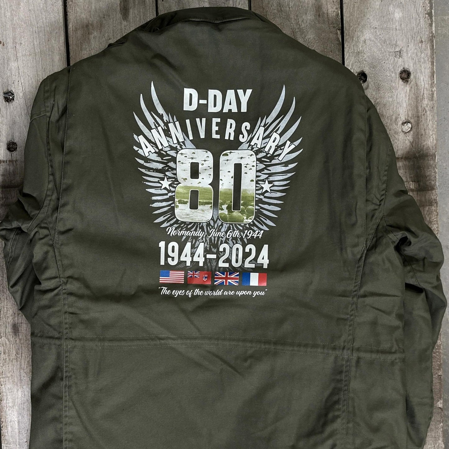 Back view of theM65 Army field coats with original D-Day 80th Anniversary design and a 48-star flag from The History List Store.