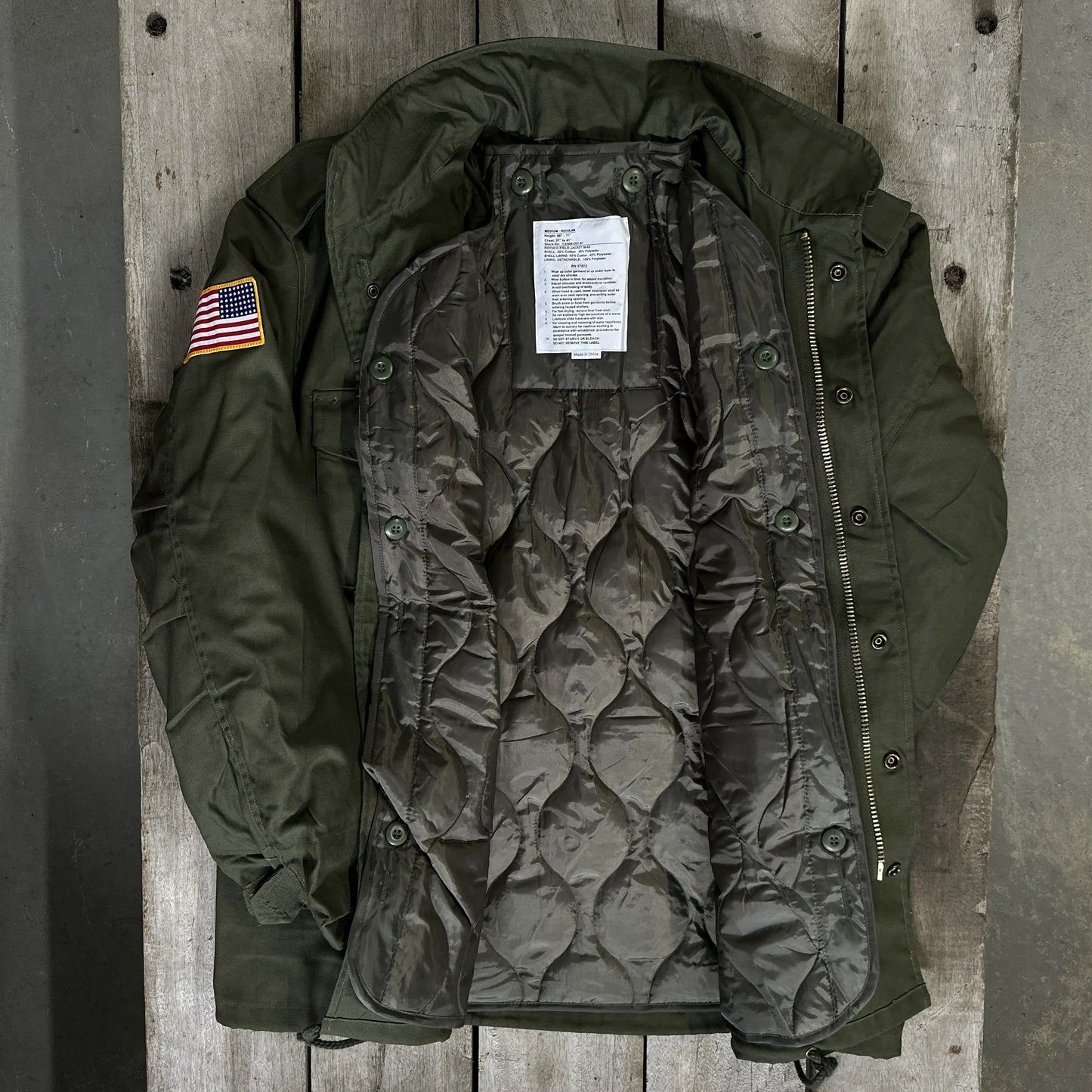 Inside detail of the M65 Army field coats with original D-Day 80th Anniversary design and a 48-star flag from The History List Store.