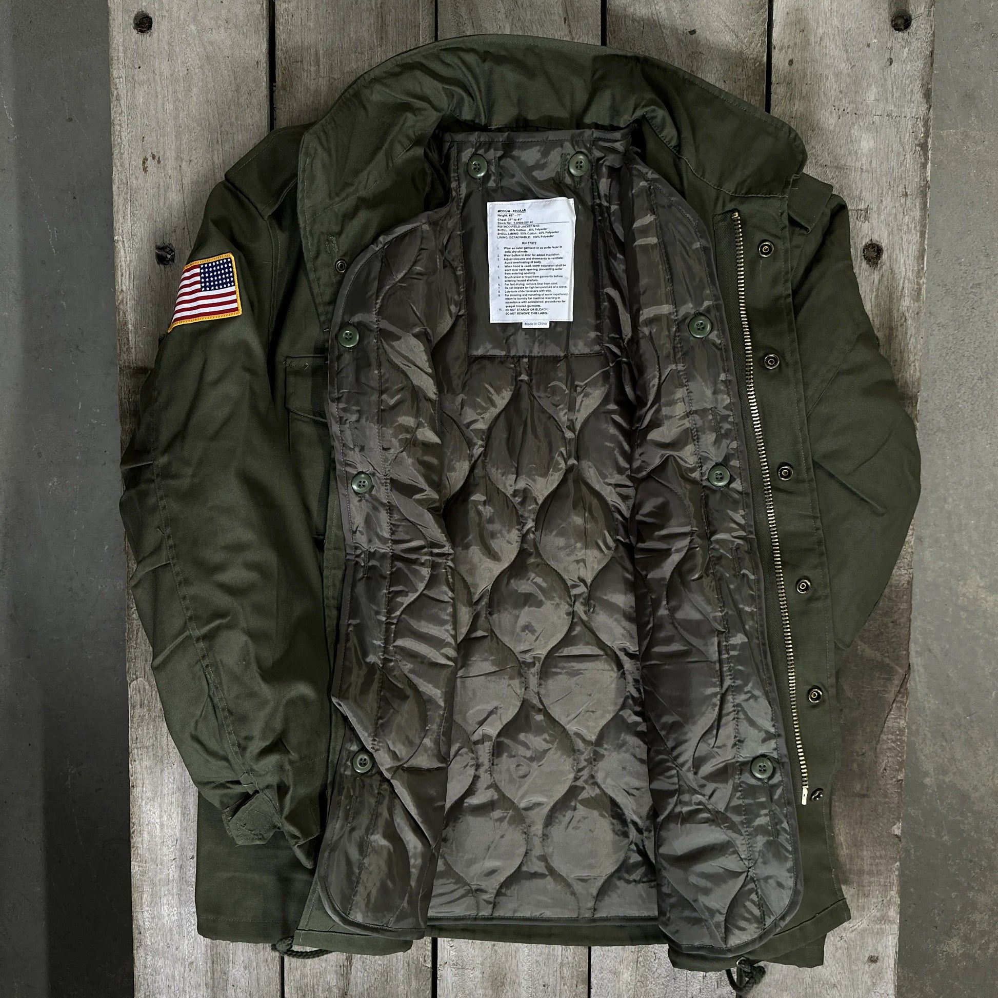 Inside detail of the M65 Army field coats with original D-Day 80th Anniversary design and a 48-star flag from The History List Store.