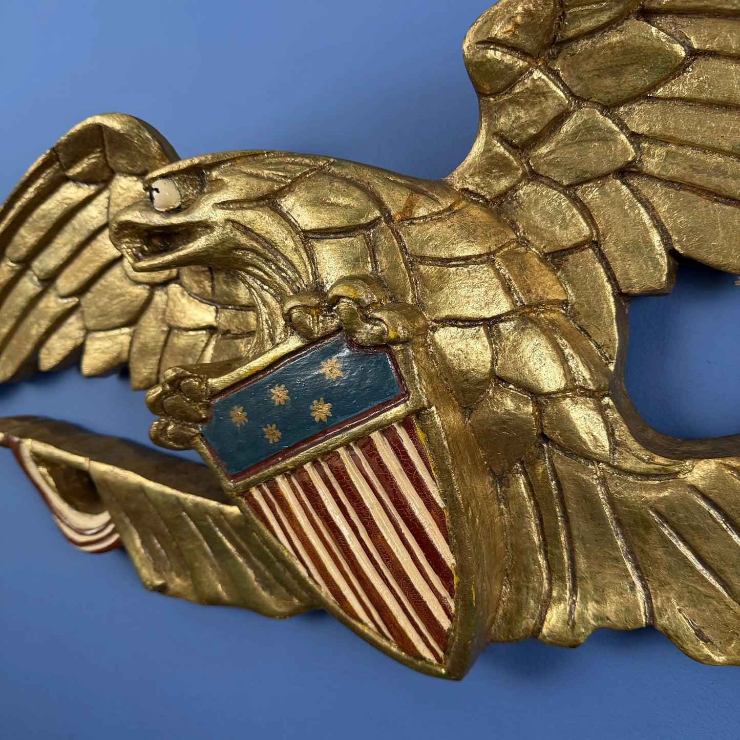 Carved wooden eagle with flag and shield — 30" wide