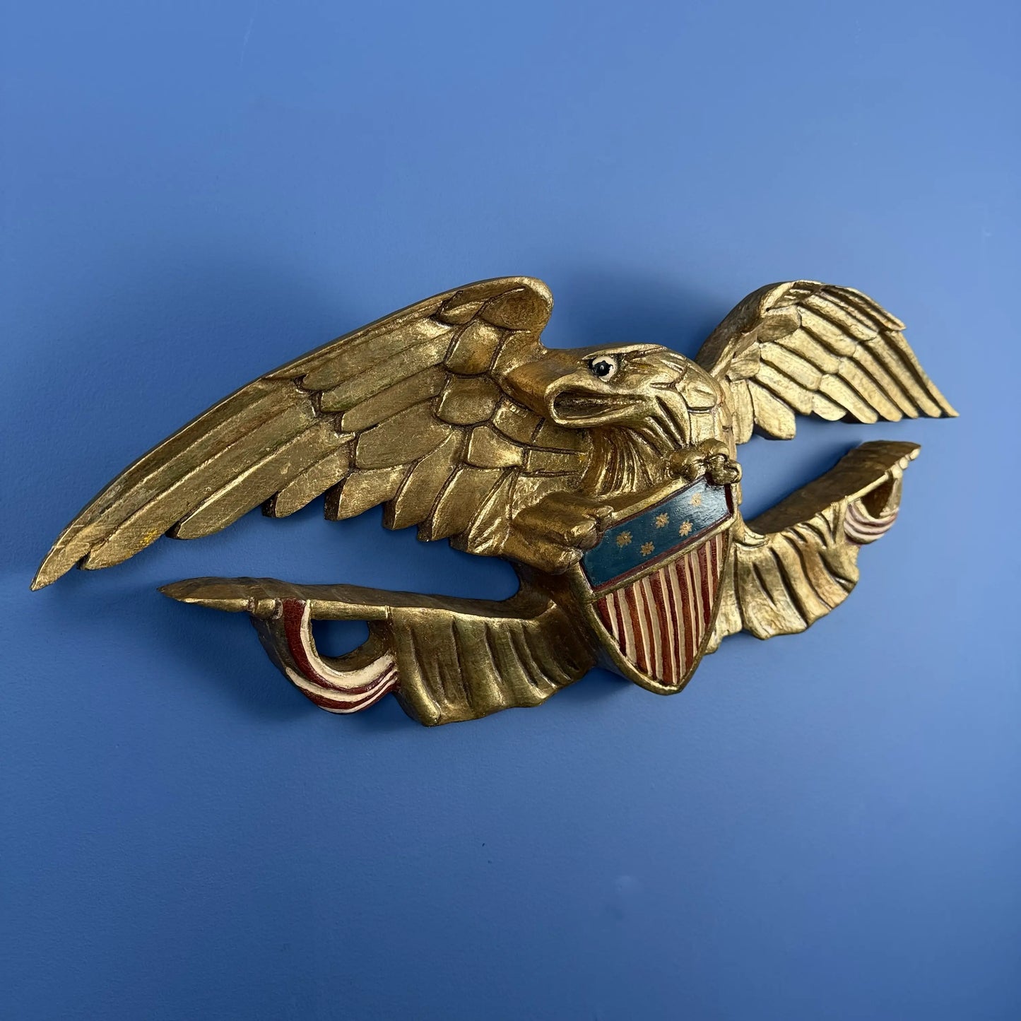 Carved wooden eagle with flag and shield — 30" wide