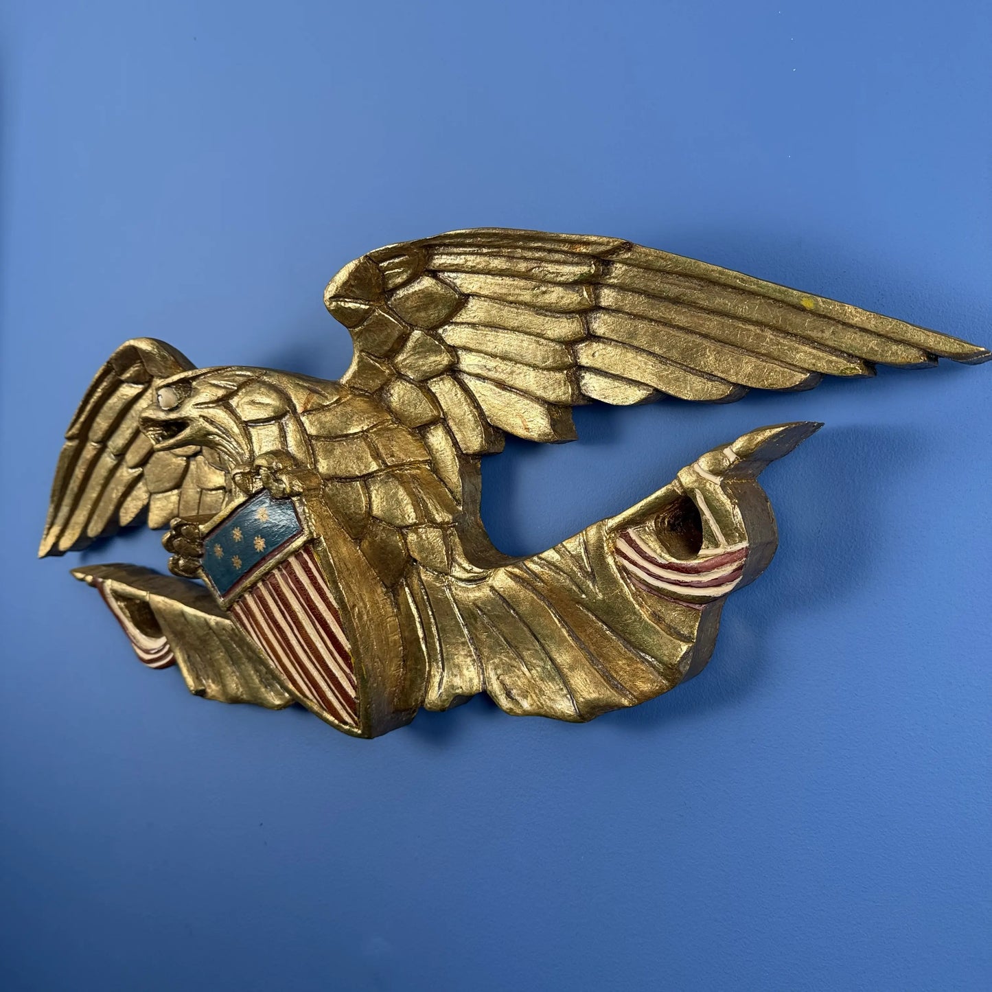 Carved wooden eagle with flag and shield — 30" wide