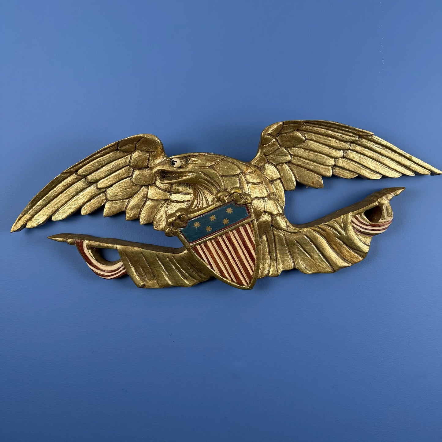 Carved wooden eagle with flag and shield — 30" wide