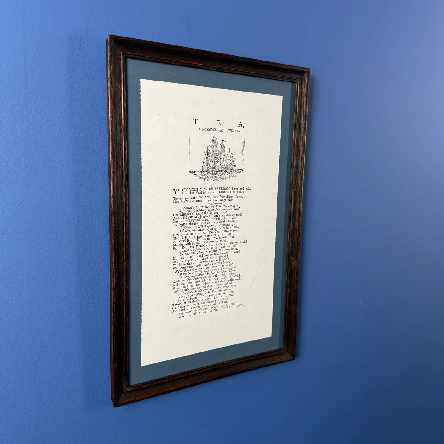 Framed "Tea Destroyed by Indians" reproduction print in an antique frame