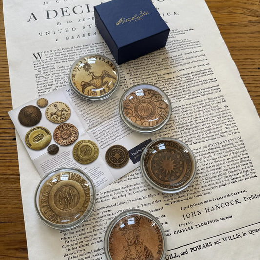 Washington Inaugural Button Glass Paperweights — Five designs — All Made in America from The History List Store with striking blue box & Washington's signature on the top and a sheet explaining the buttons.