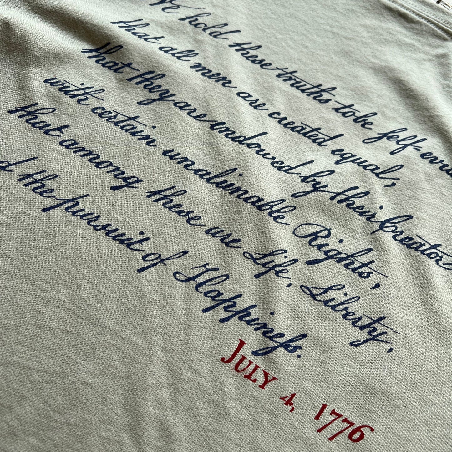 Close-up of back of "We hold these truths - July 4, 1776" v-neck shirt from The History List store in Silver