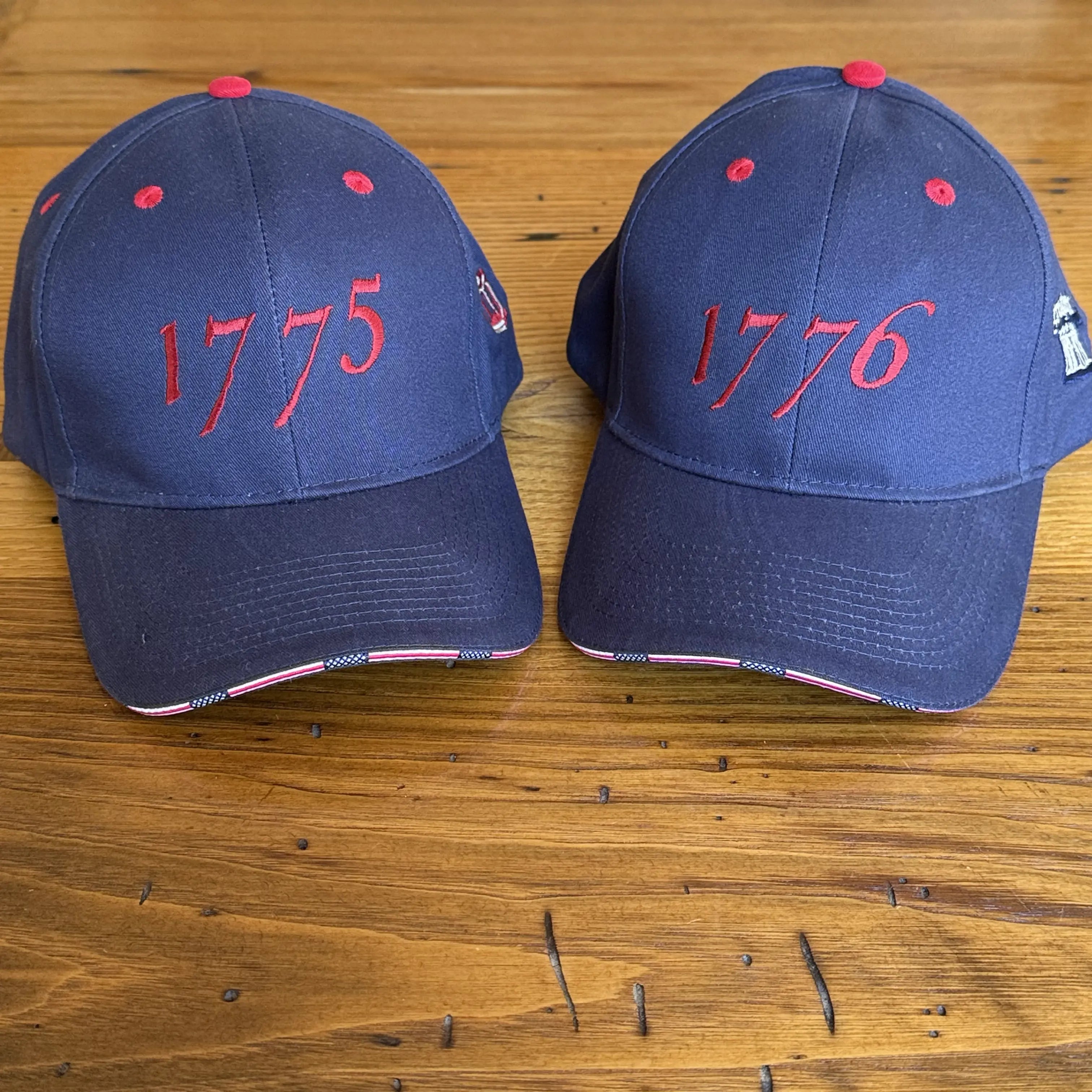 Side by side Embroidered "1775 Battle of Lexington" cap with Old North Church Lantern and 1776 cap with Proclaim Liberty from The History List store
