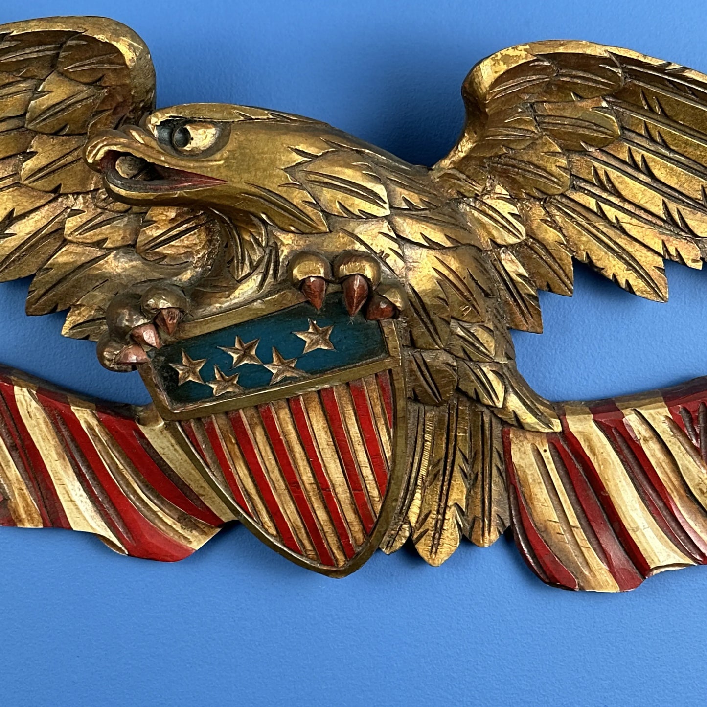 Carved wooden eagle with a shield and two flags — 29” wide