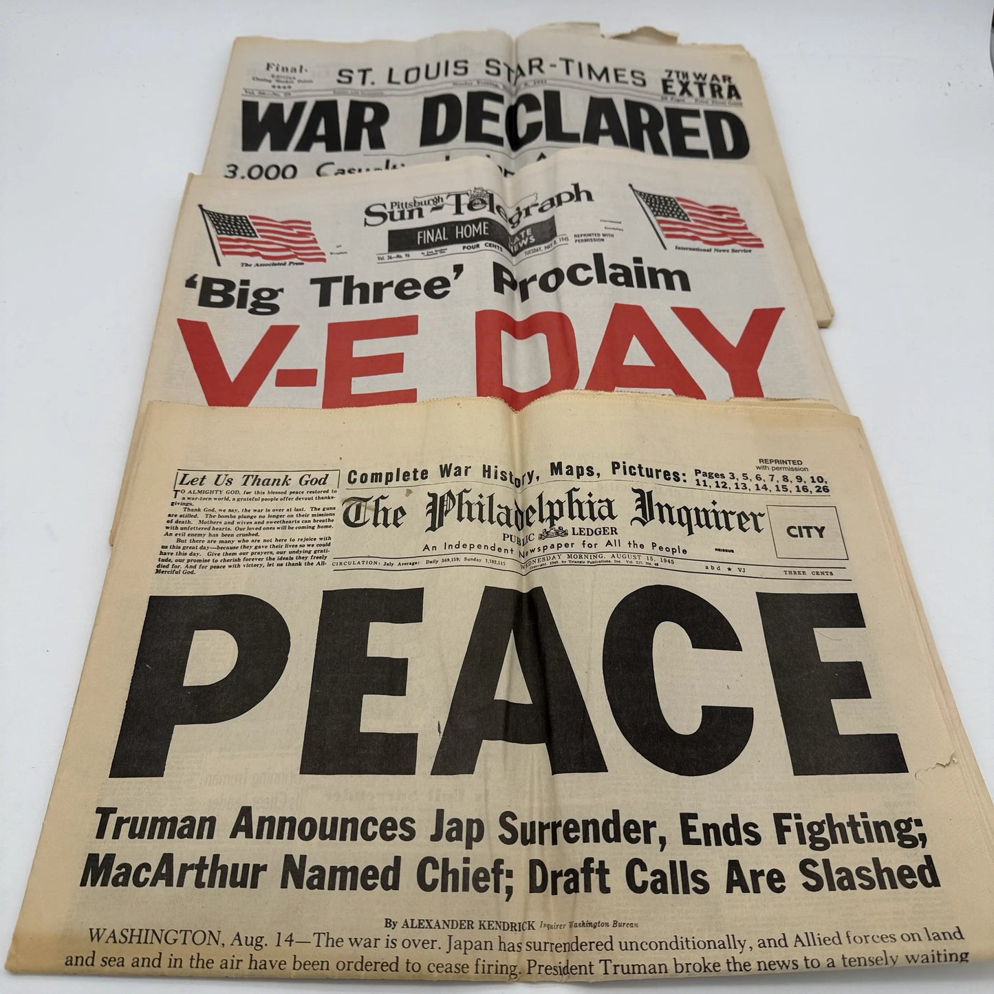 Three WWII newspapers —War Declared, V-E Day, Peace