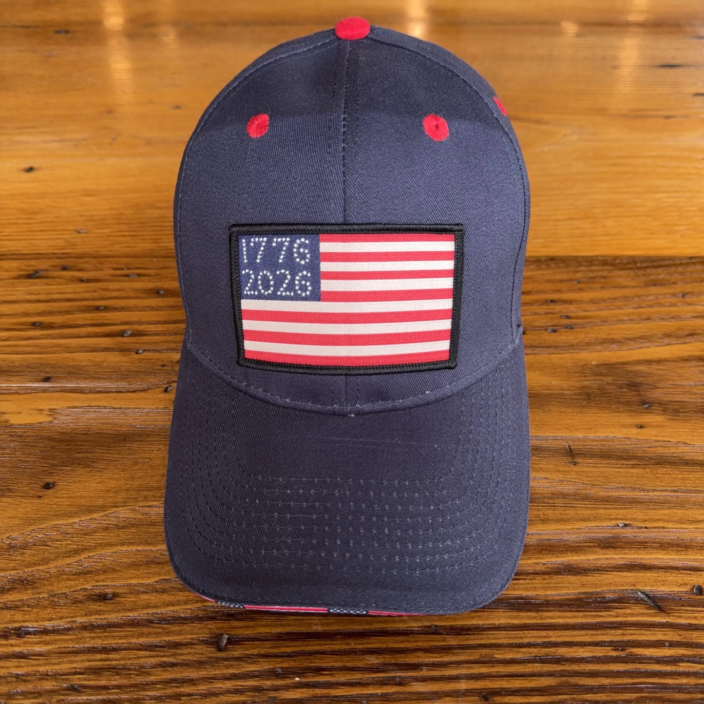 1776 - 2026 "Let Freedom Ring" cap — Dark blue with flag brim