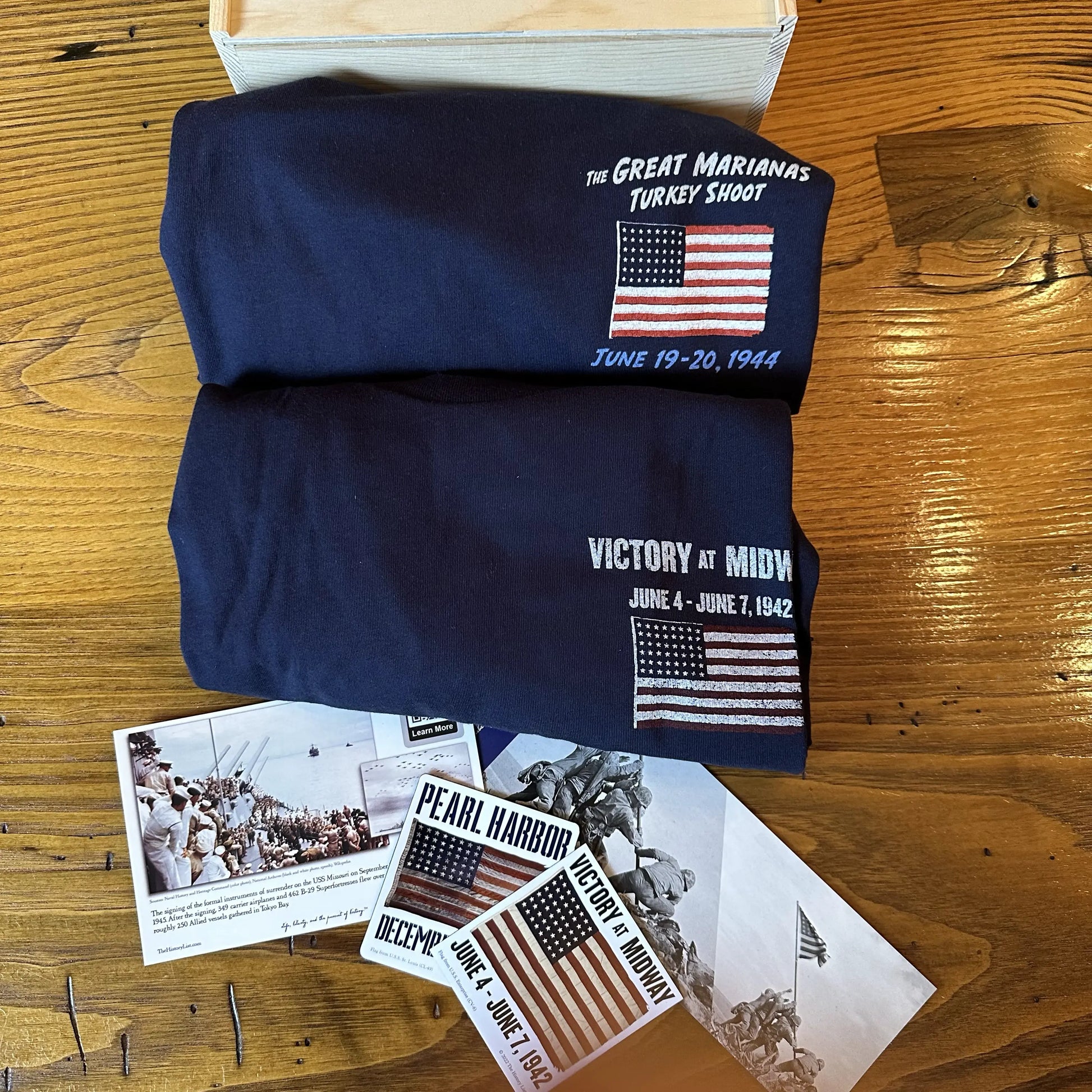 WWII Victory Box with "Victory at Midway" Shirt and "The Great Marianas Turkey Shoot" Shirt along with stickers and bookmarks from The History List Store