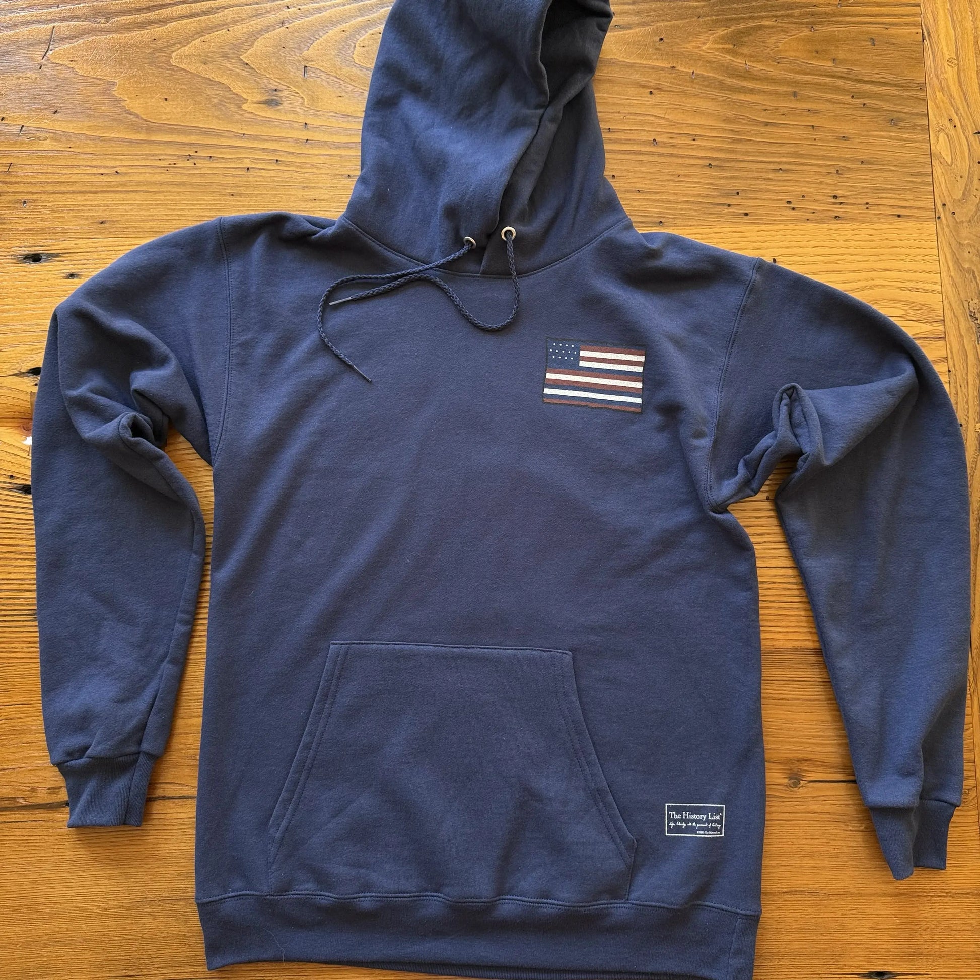 Front of The Continental Navy Hooded Sweatshirt from The History List Store