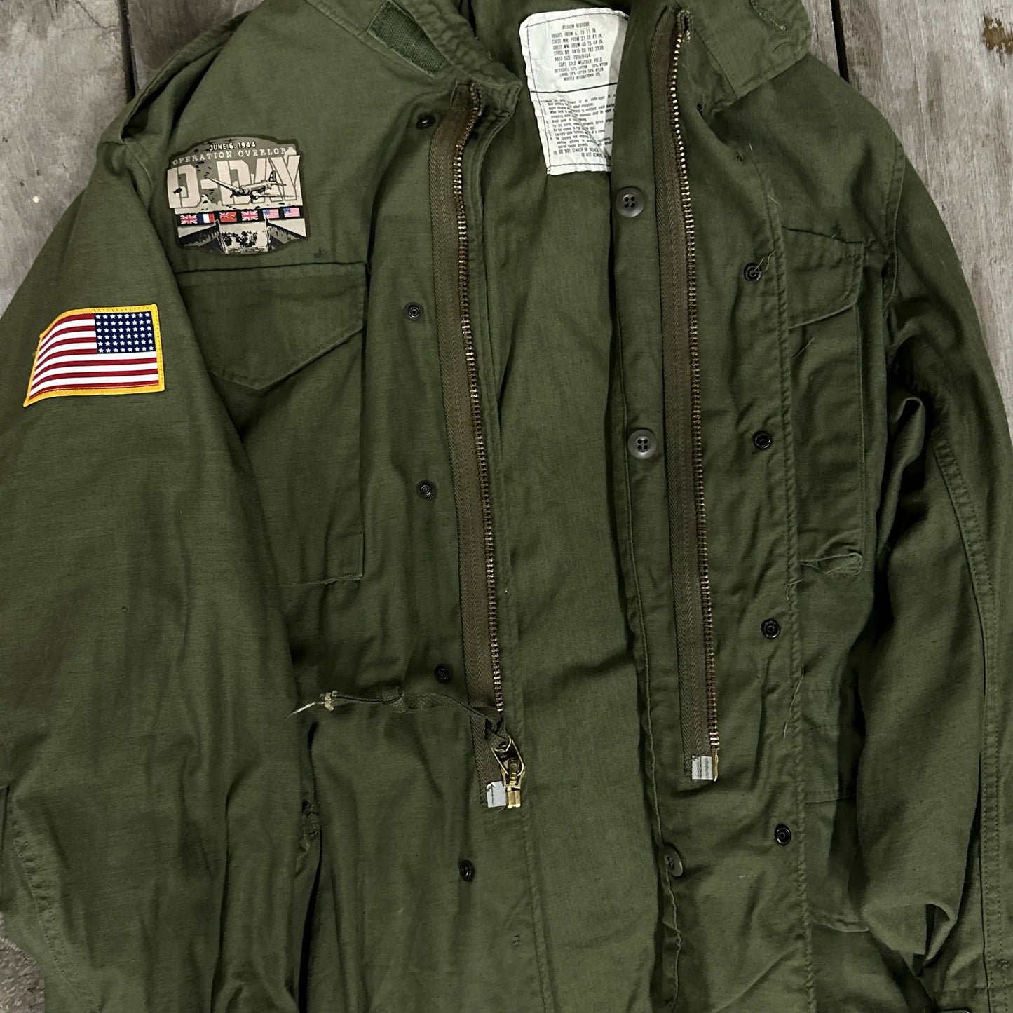 M65 Army field coats with original D-Day Operation Overlord design and a 48-star flag