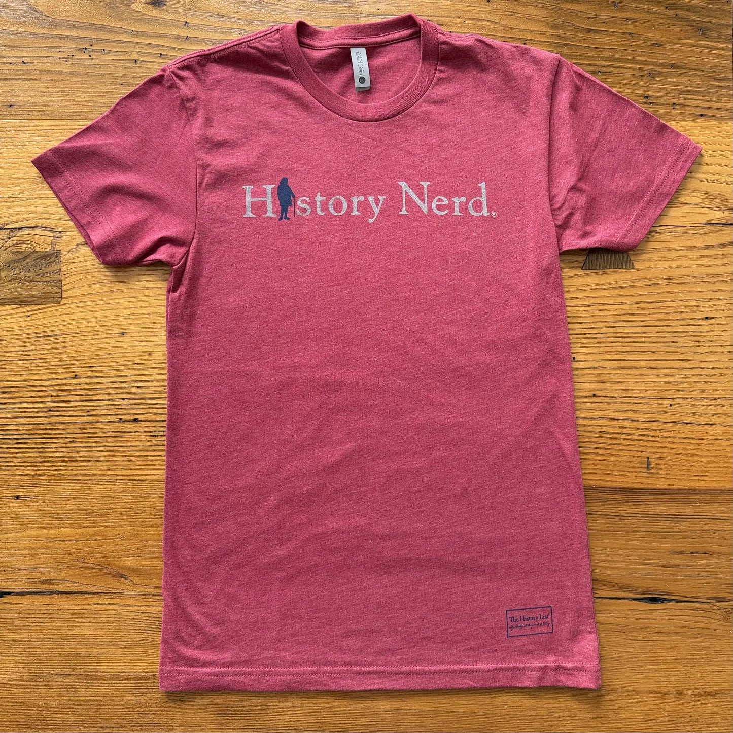 Cardinal red t-shirt with 'History Nerd' text on a wooden surface from The History List store