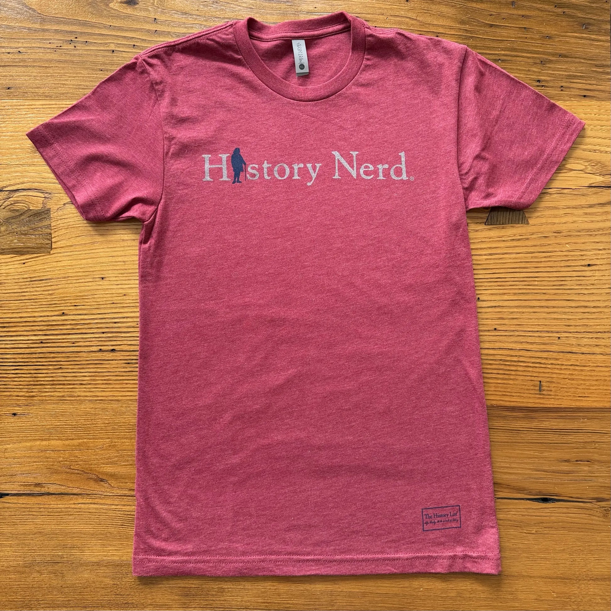 Cardinal red t-shirt with 'History Nerd' text on a wooden surface from The History List store