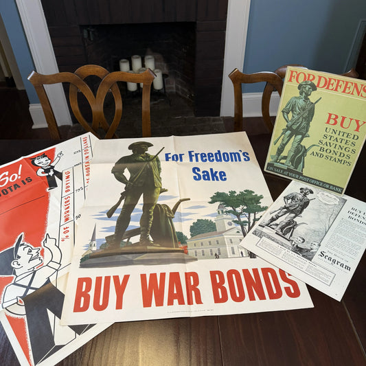 WWII War Bond drive materials, including "For Freedom's Sake" poster, sign, ad