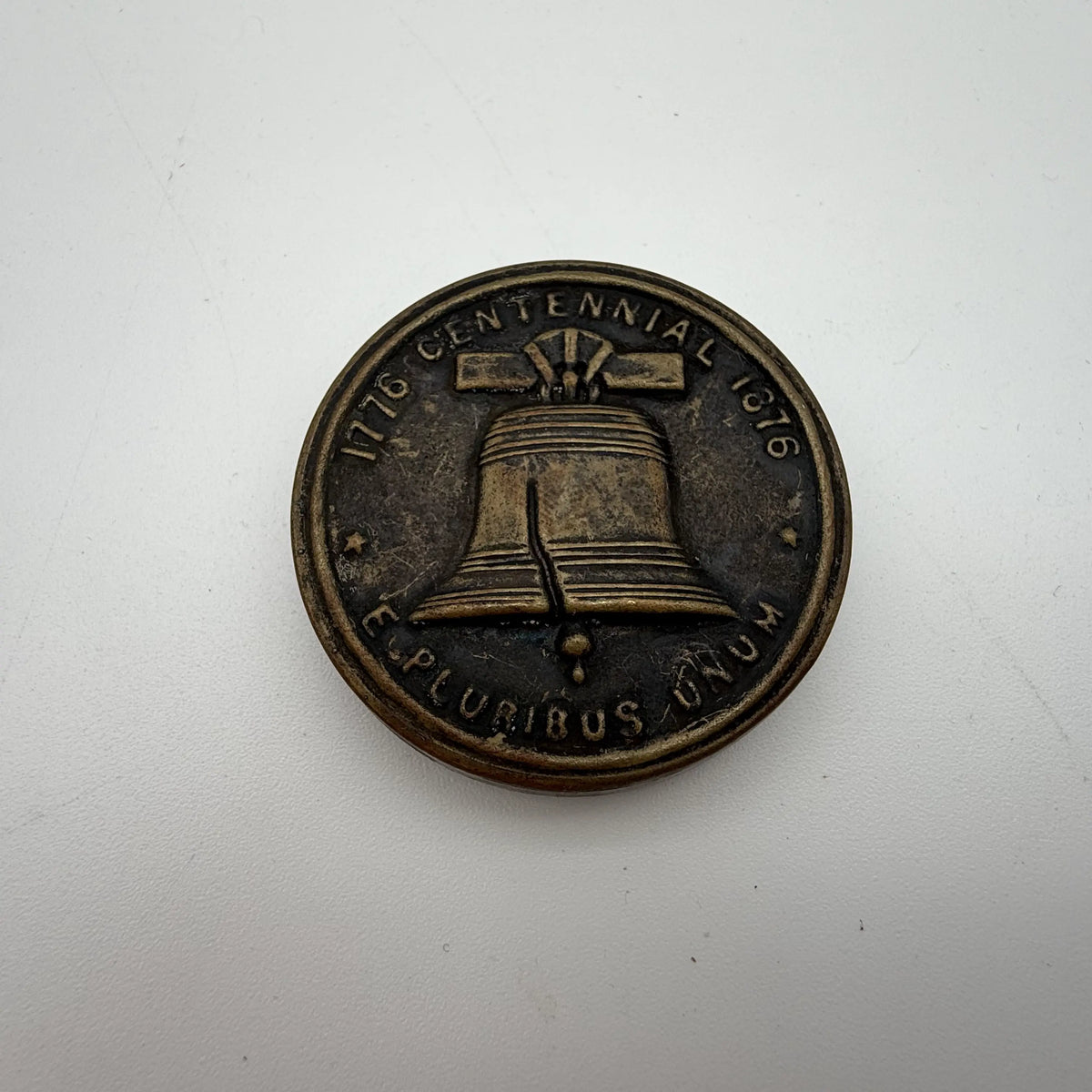 Centennial "token" with 14 small photos of Philadelphia historic sites enclosed