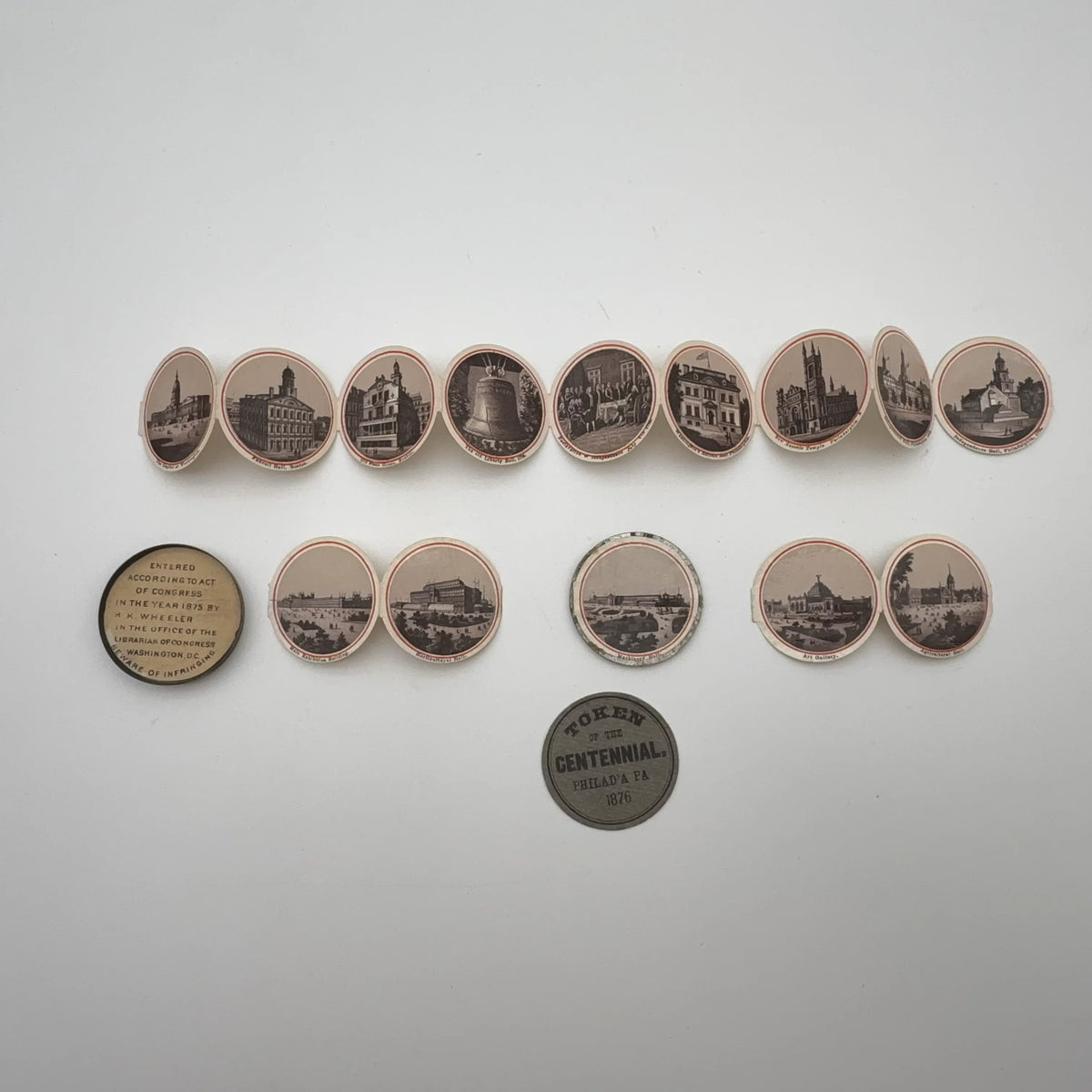Centennial "token" with 14 small photos of Philadelphia historic sites enclosed