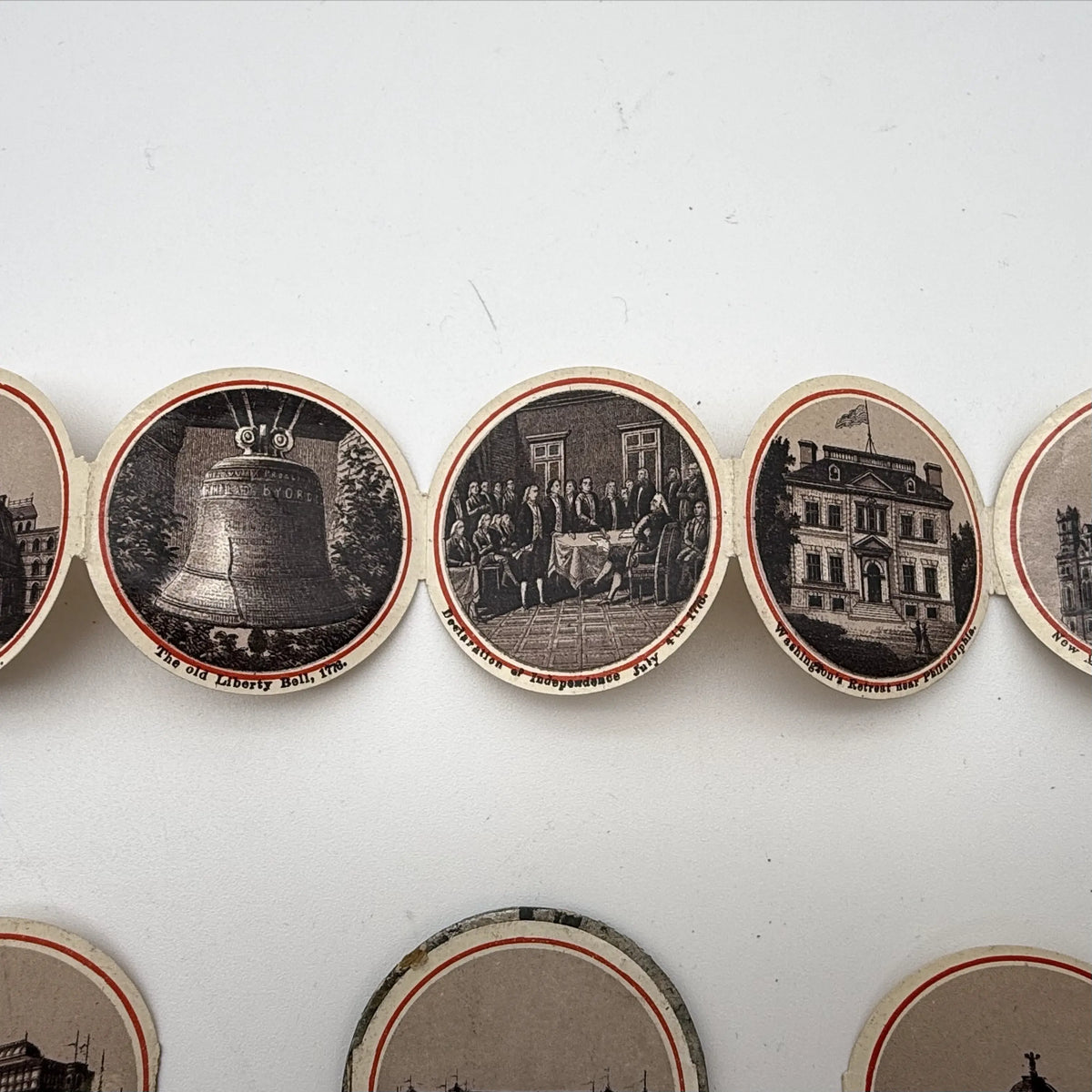 Centennial "token" with 14 small photos of Philadelphia historic sites enclosed