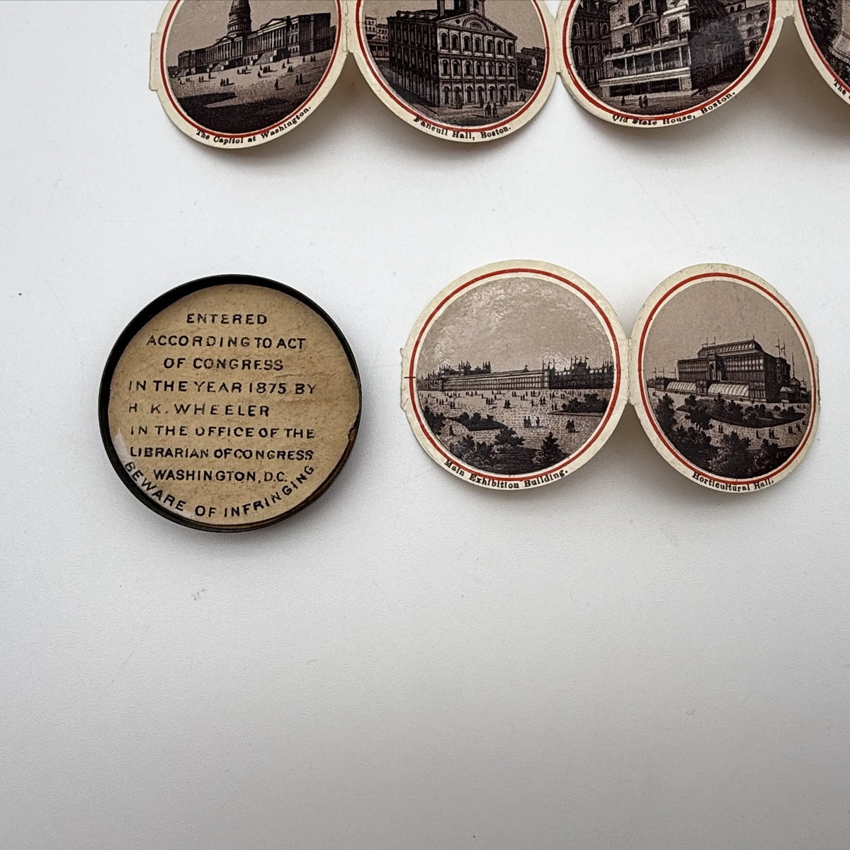 Centennial "token" with 14 small photos of Philadelphia historic sites enclosed