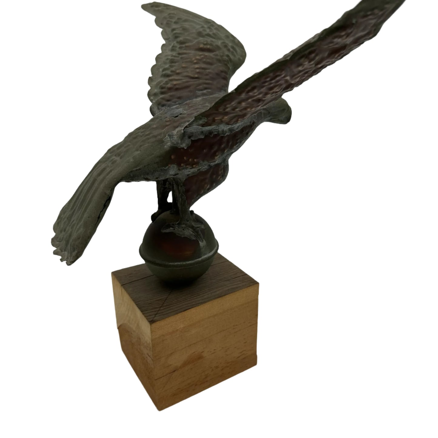 Copper eagle on ball on wooden block