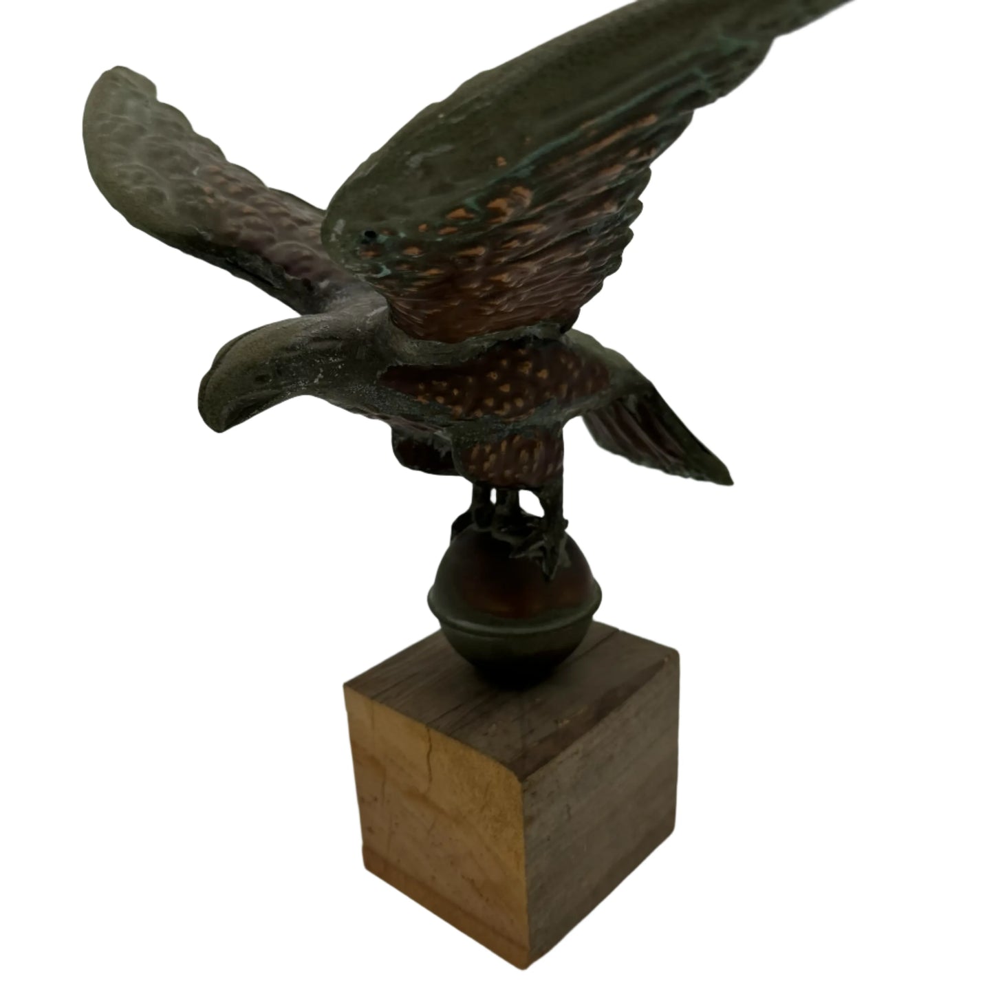 Copper eagle on ball on wooden block