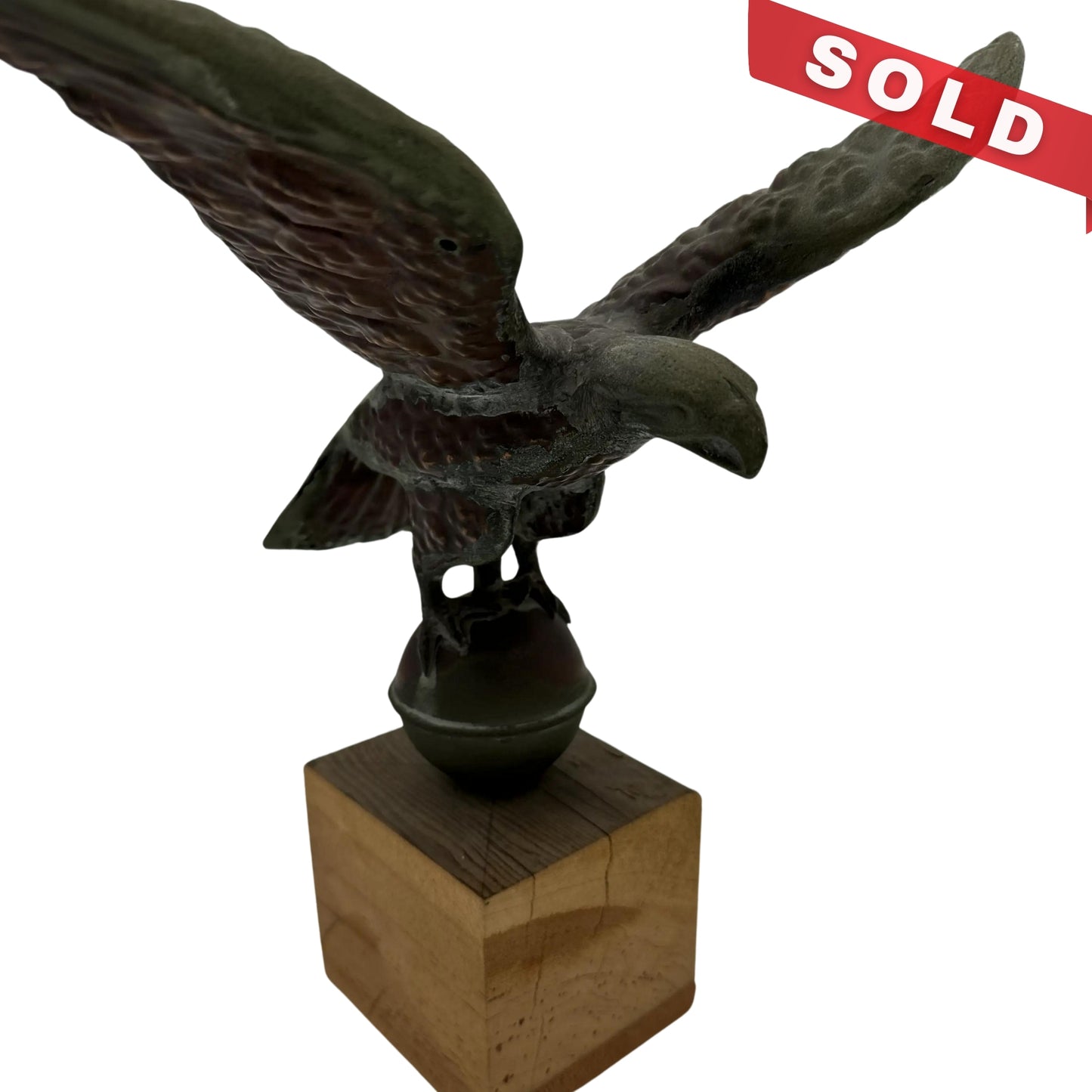 Copper eagle on ball on wooden block