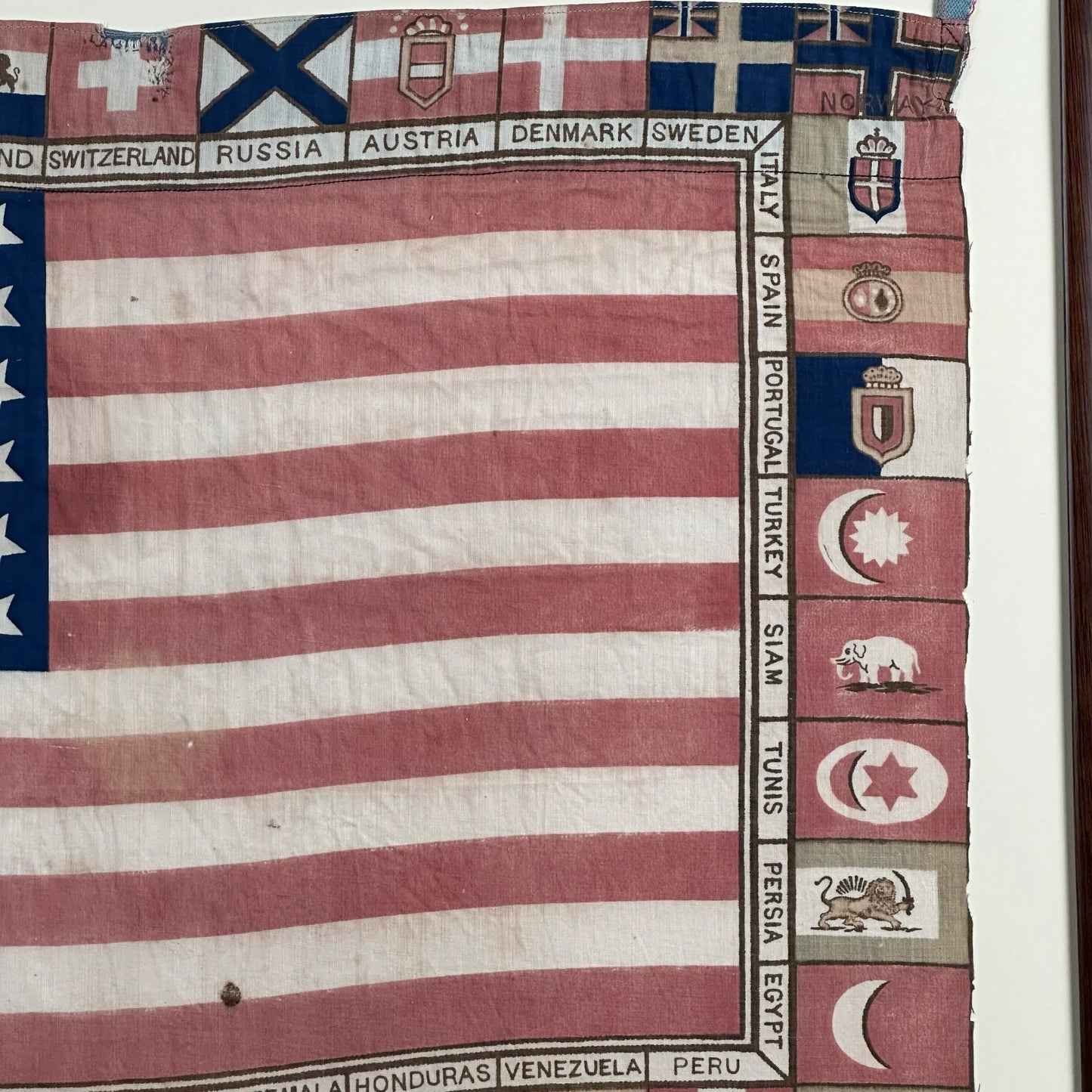 Printed for the 1875 Centennial Exhibition: US flag surrounded with the flags of participating nations — Framed