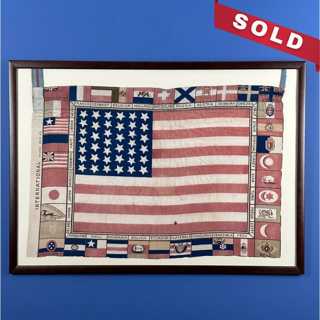 Printed for the 1876 Centennial Exhibition: US flag surrounded with the flags of participating nations — Framed