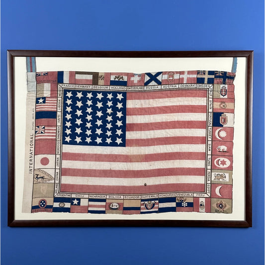 Printed for the 1875 Centennial Exhibition: US flag surrounded with the flags of participating nations — Framed