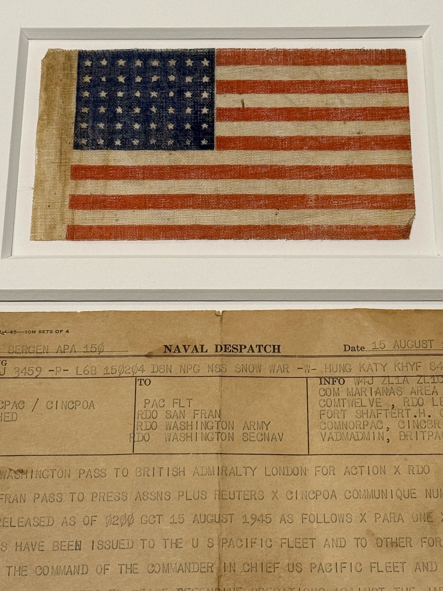 Naval despatch on August 15, 1945, announcing the end of the war in the Pacific, with 48-star flag — matted and framed