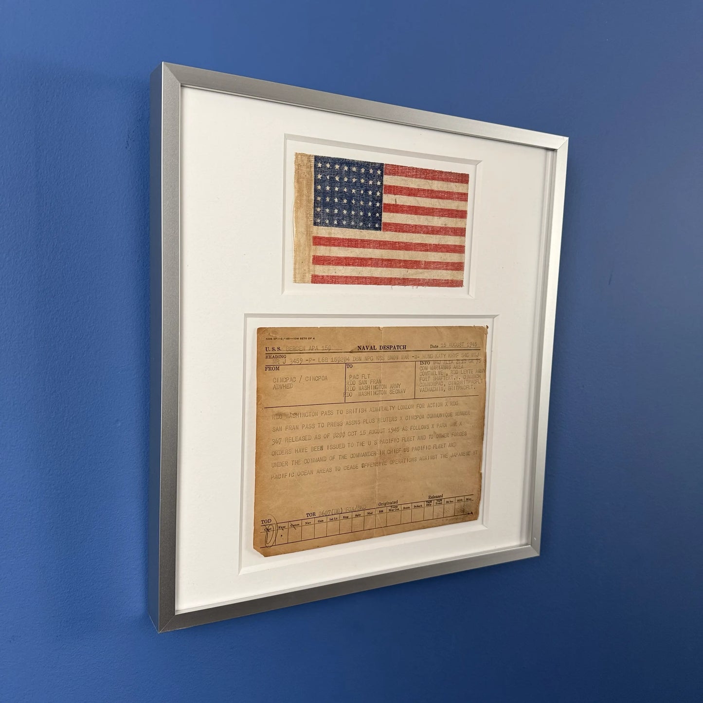 Naval despatch on August 15, 1945, announcing the end of the war in the Pacific, with 48-star flag — matted and framed