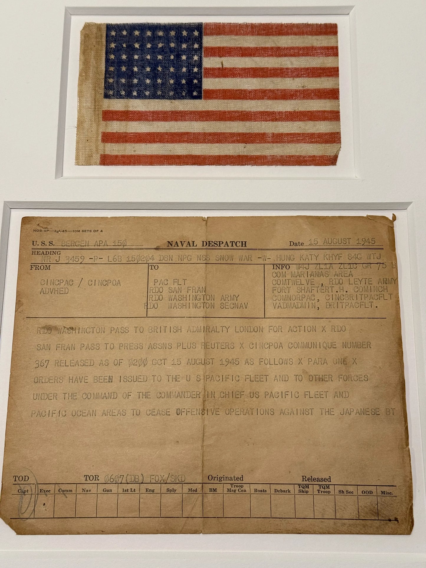 Naval despatch on August 15, 1945, announcing the end of the war in the Pacific, with 48-star flag — matted and framed