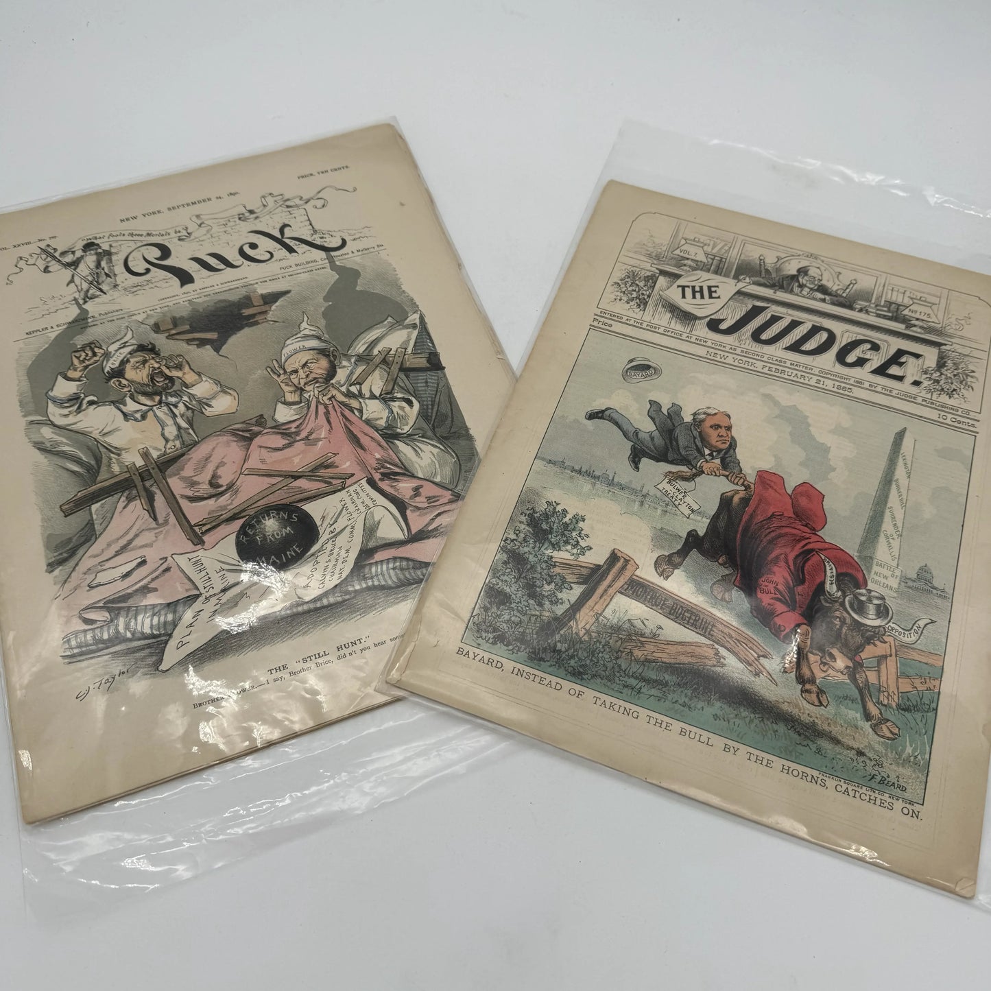 "Puck" and "Judge" Magazines — 1881 - 1905 — Fourteen issues in an archival box