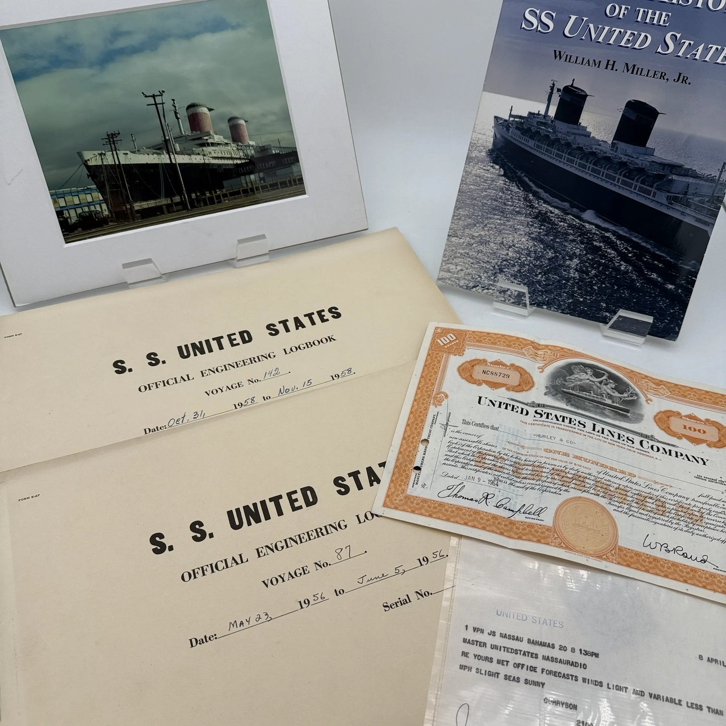 SS United States place setting with book, documents, stock certificate