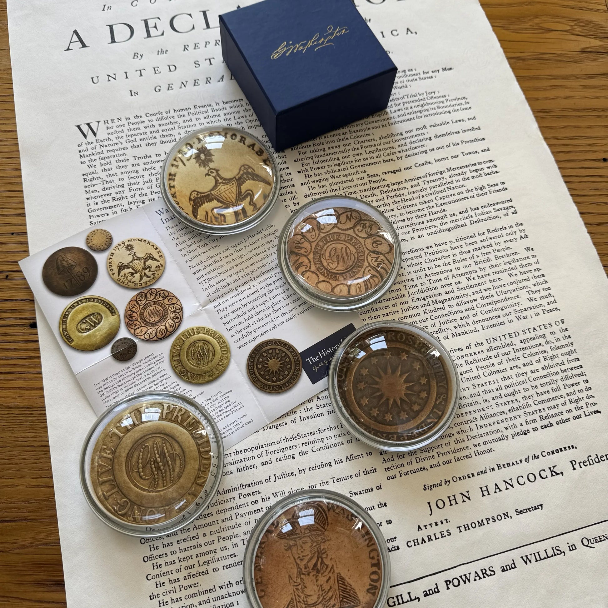 Washington Inaugural Button Glass Paperweights — Five designs — All Made in America from The History List Store with striking blue box & Washington's signature on the top and a sheet explaining the buttons. 
