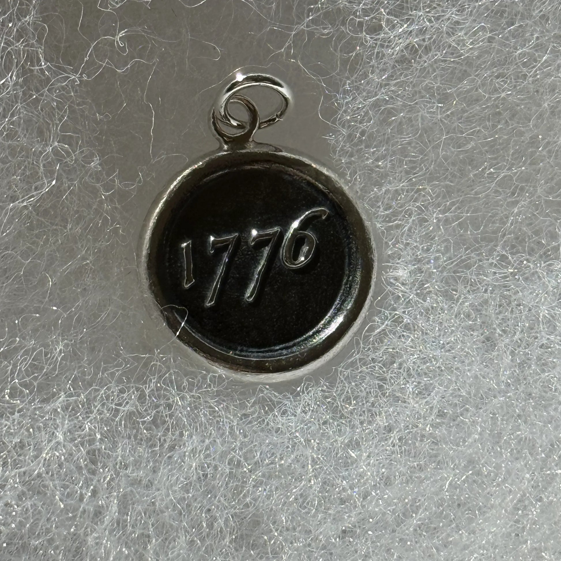Close up of the 1776 Revolutionary sterling silver charms made by hand in New England from The History List Store.