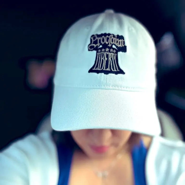 When worn of the Embroidered "Proclaim Liberty" cap with the Liberty Bell — White from The History List Store.
