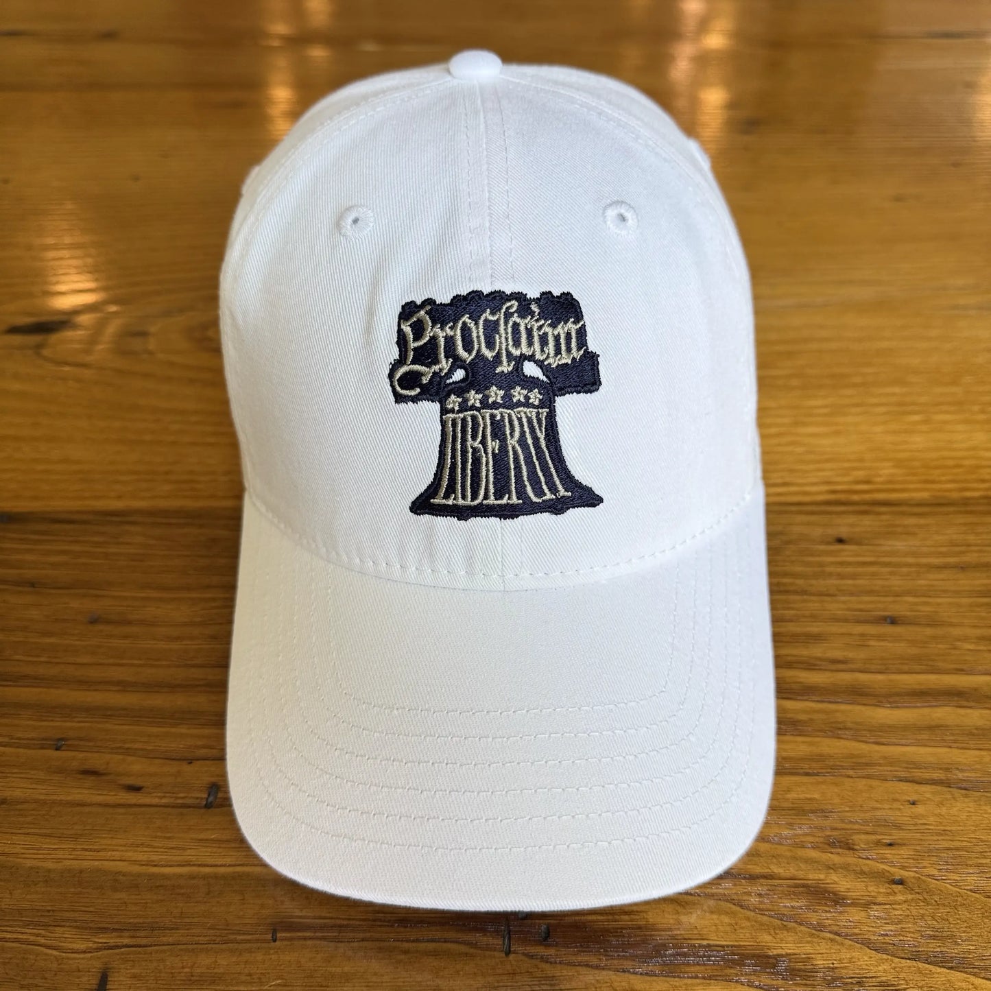 Embroidered "Proclaim Liberty" cap with the Liberty Bell — White from The History List Store.