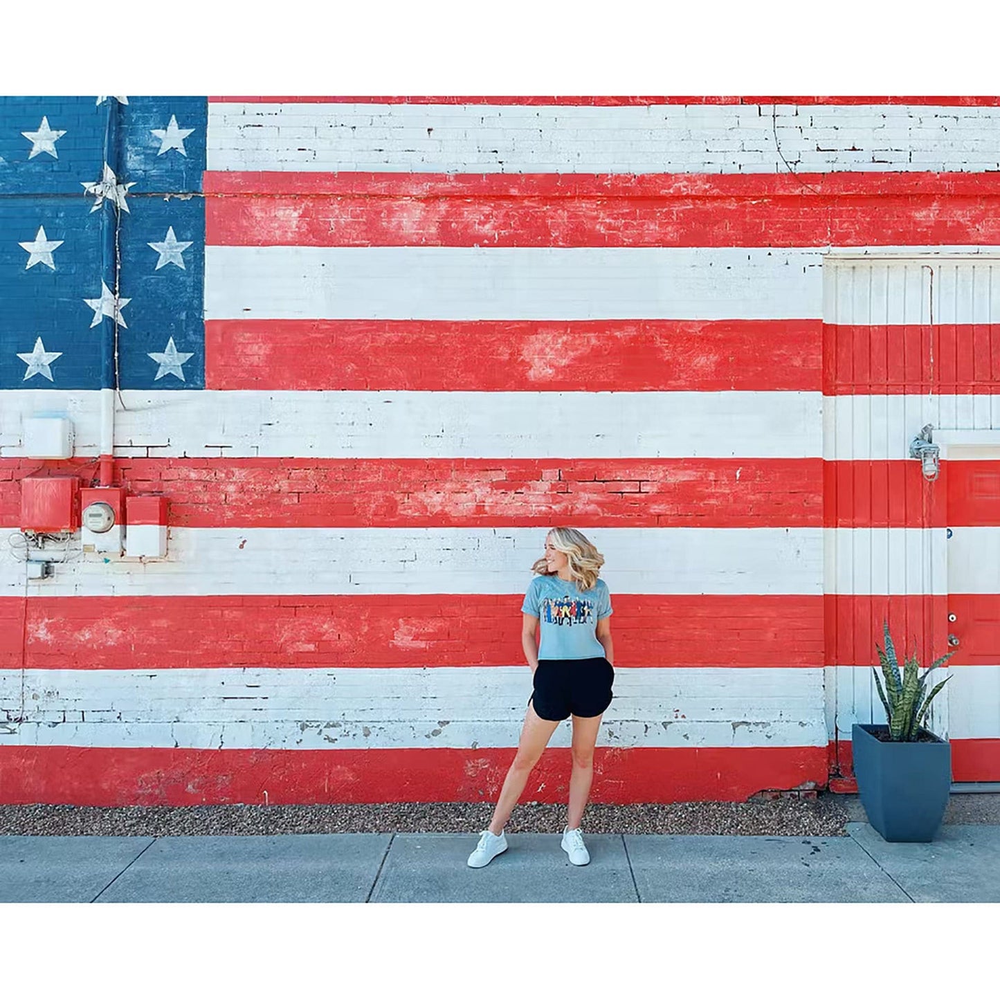 NJ's photo with flag on background while wearing the Ten "Revolutionary Superheroes" T-Shirt in Dark grey from The History List store from the history list store