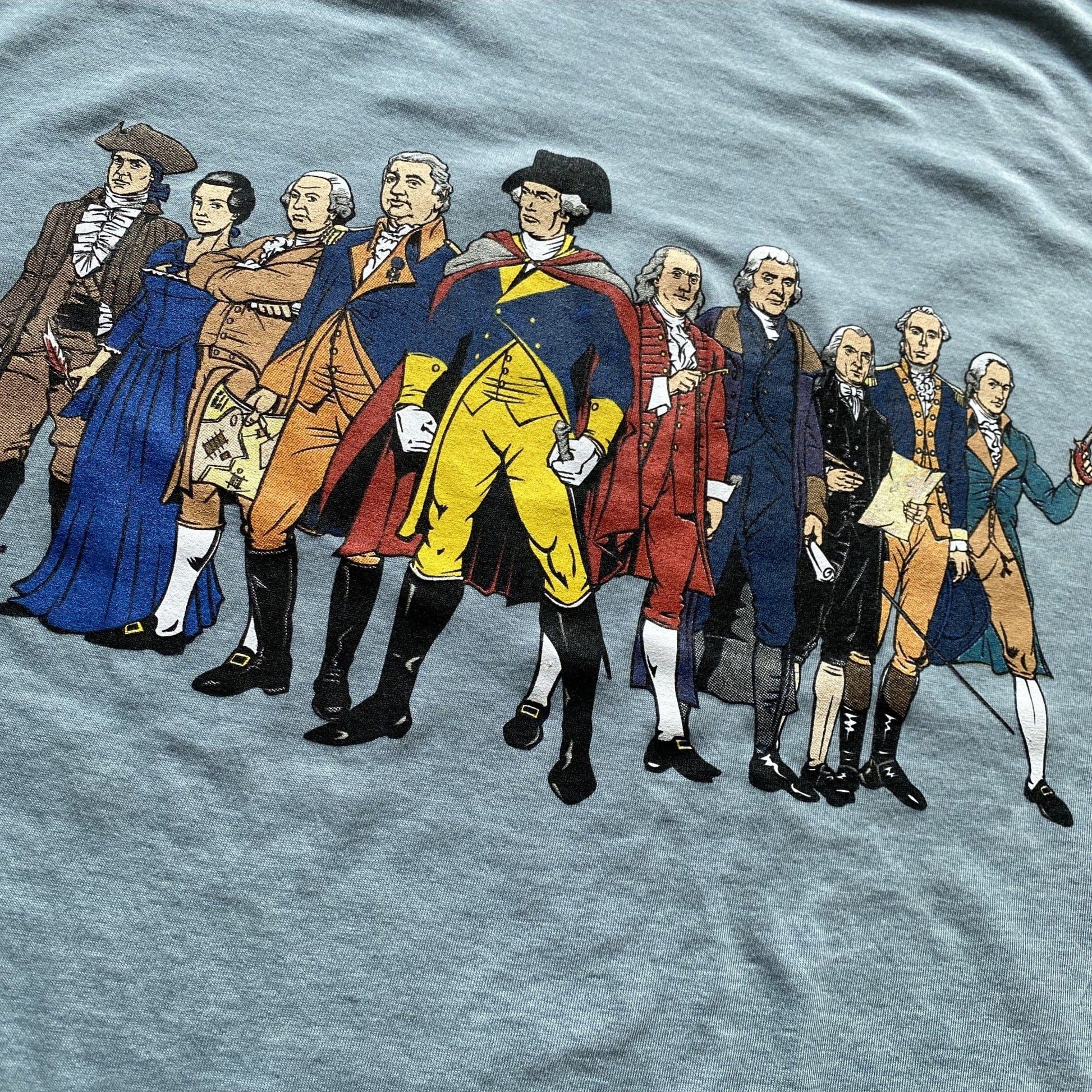 Close-up of Ten "Revolutionary Superheroes" T-Shirt in Light blue heather from The History List store