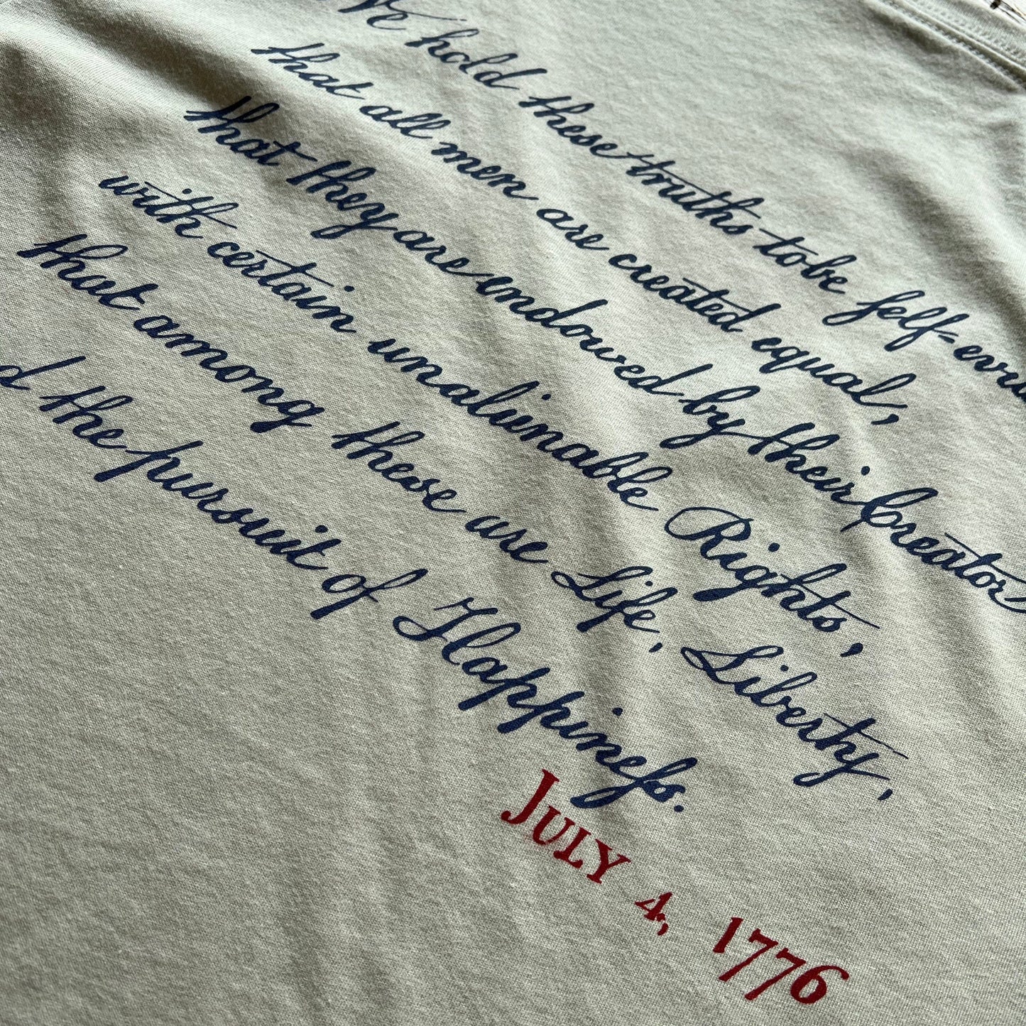 Close-up of back of "We hold these truths - July 4, 1776” v-neck shirt from The History List store in Silver